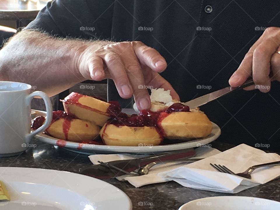 Canadian style waffles topped with fruit, berries and whipped cream