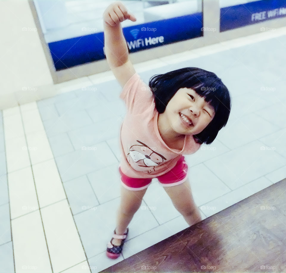 Very excited Asian girl about the age 4 years out for free Wi-Fi.