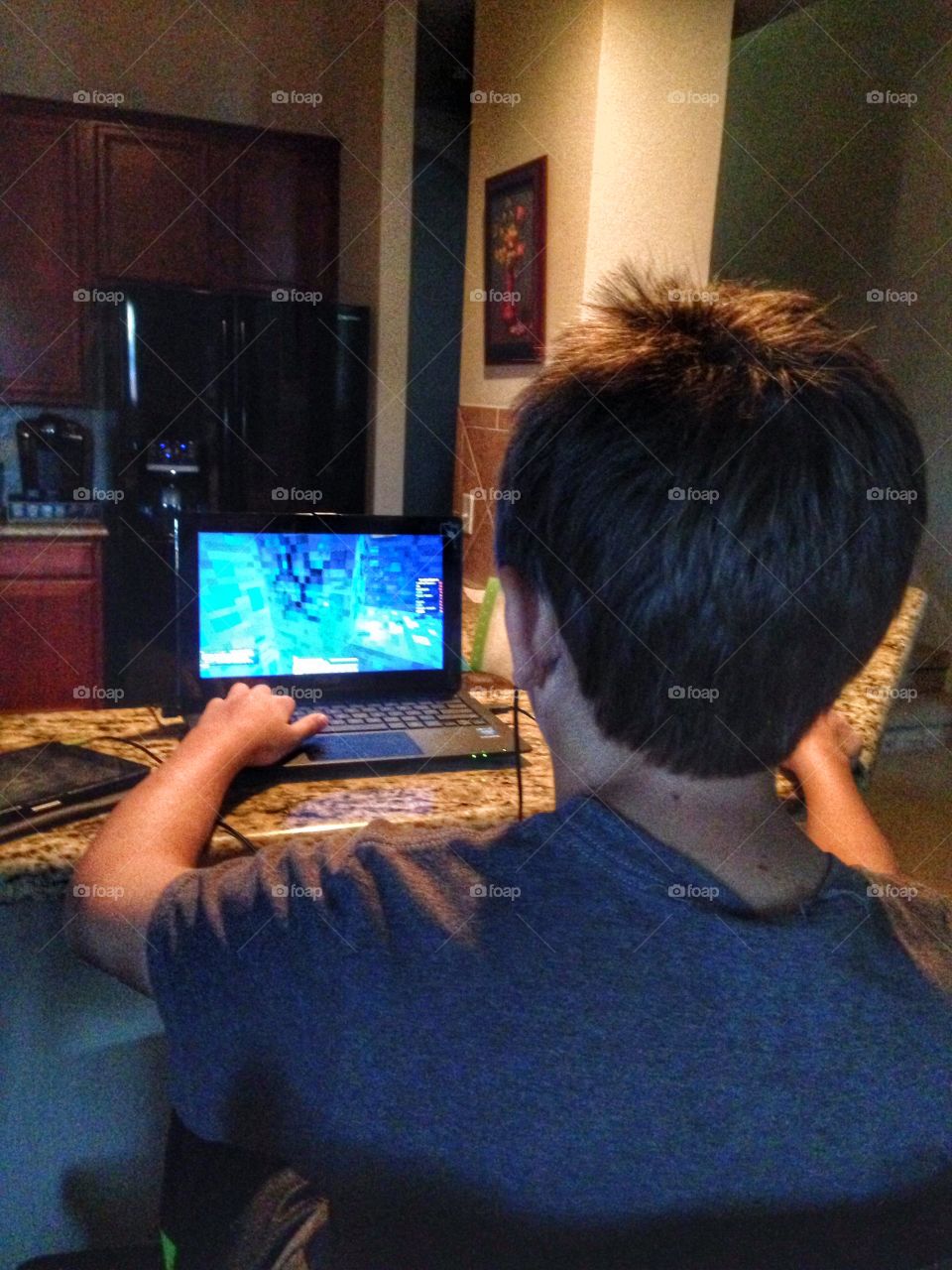 Minecraft warrior . Boy playing minecraft on laptop