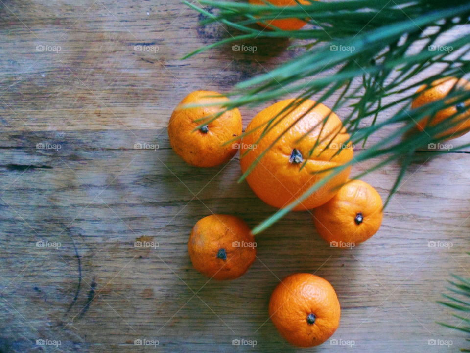 orange and tangerines are on the table