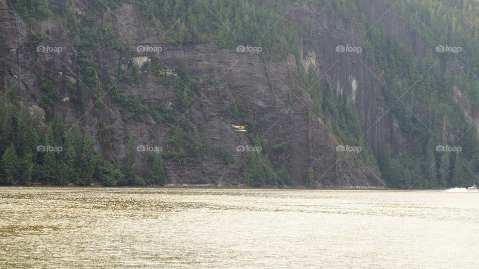 Tiny plane, majestic mountains