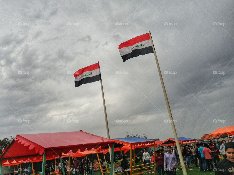 Flag of the State of Iraq raised in the rain