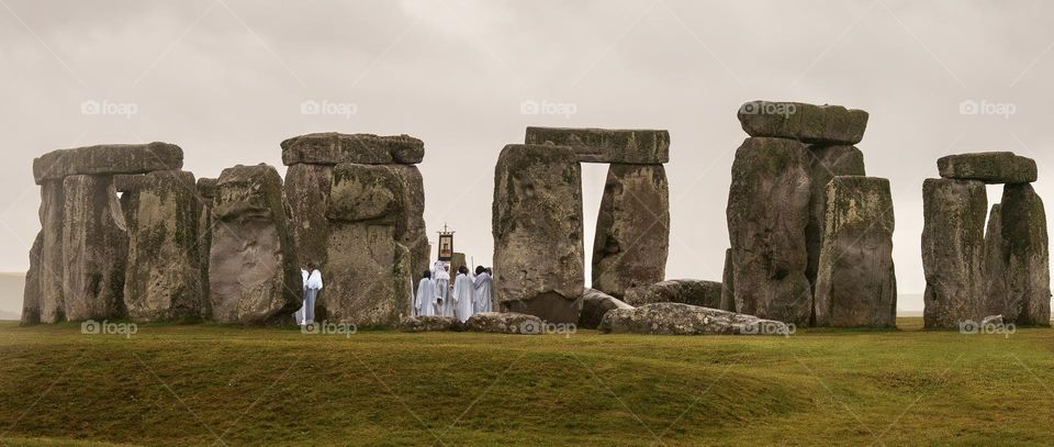 A crowd of druids perform solstice rituals at Stonehenge.