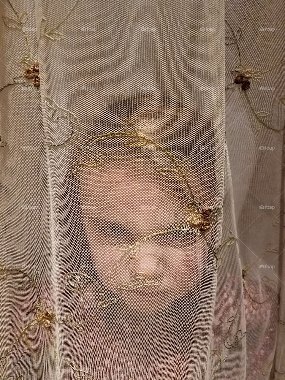 Angry girl behind curtain