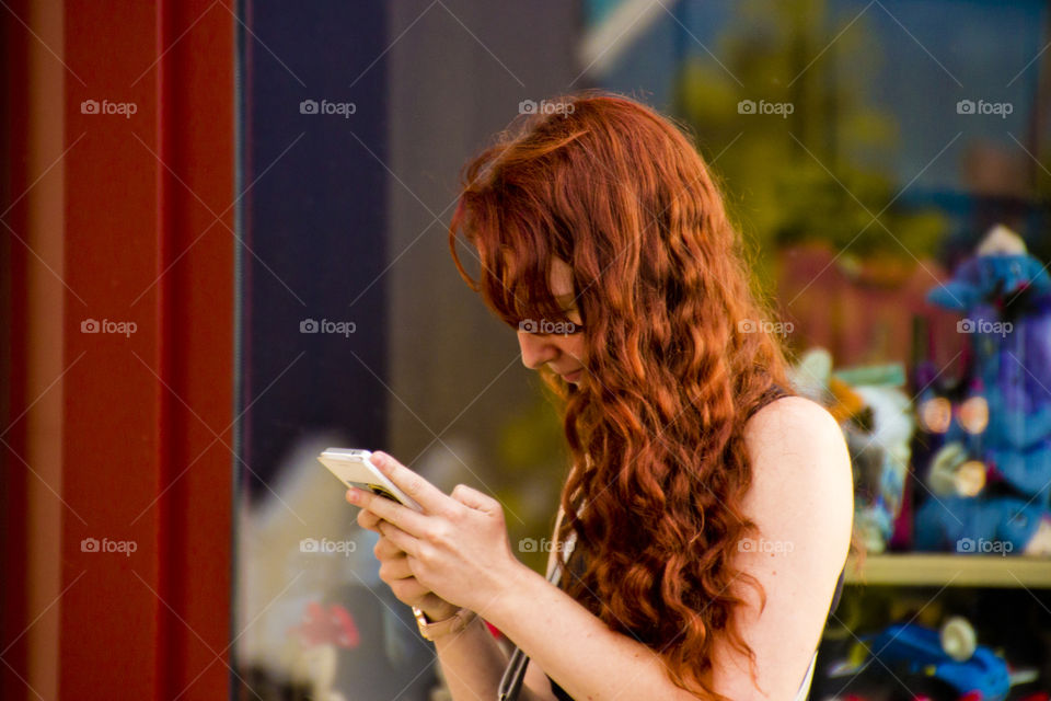 Red hairstyle, Red hair girl with smartphone