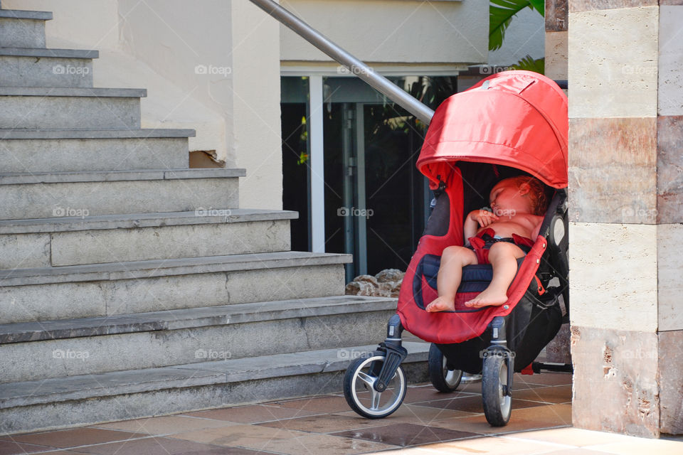 Baby girl sleeping in her stroller.