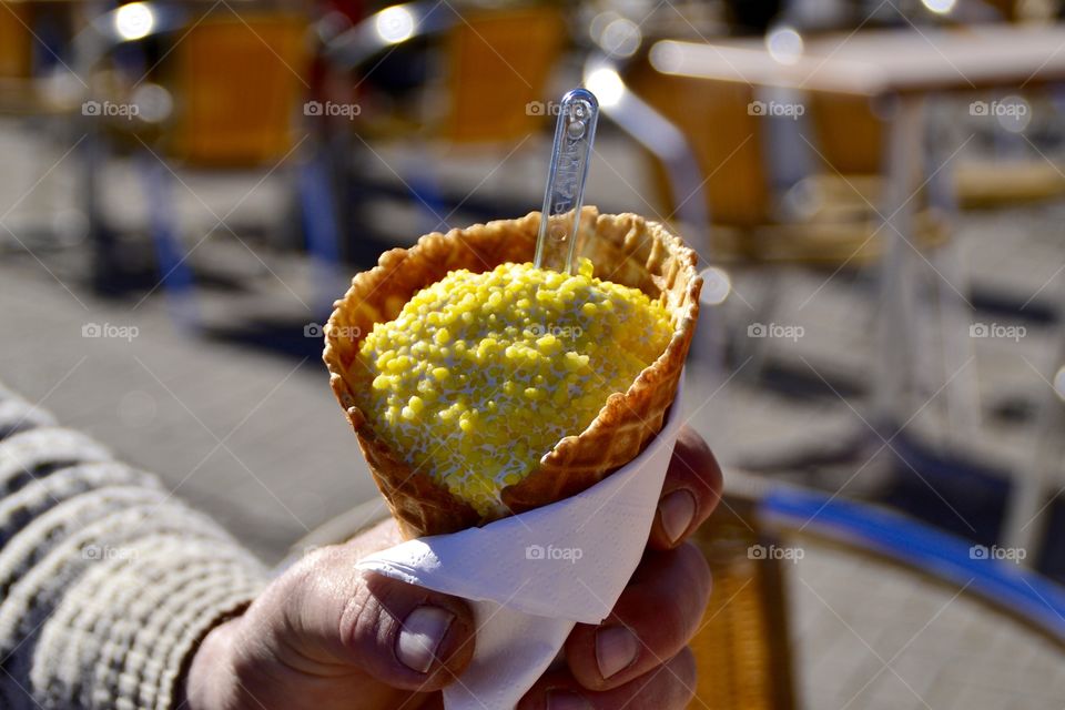 Person's hand holding waffle cone