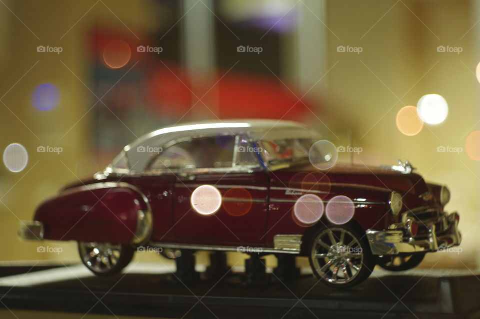 Classic car model in window with bokeh