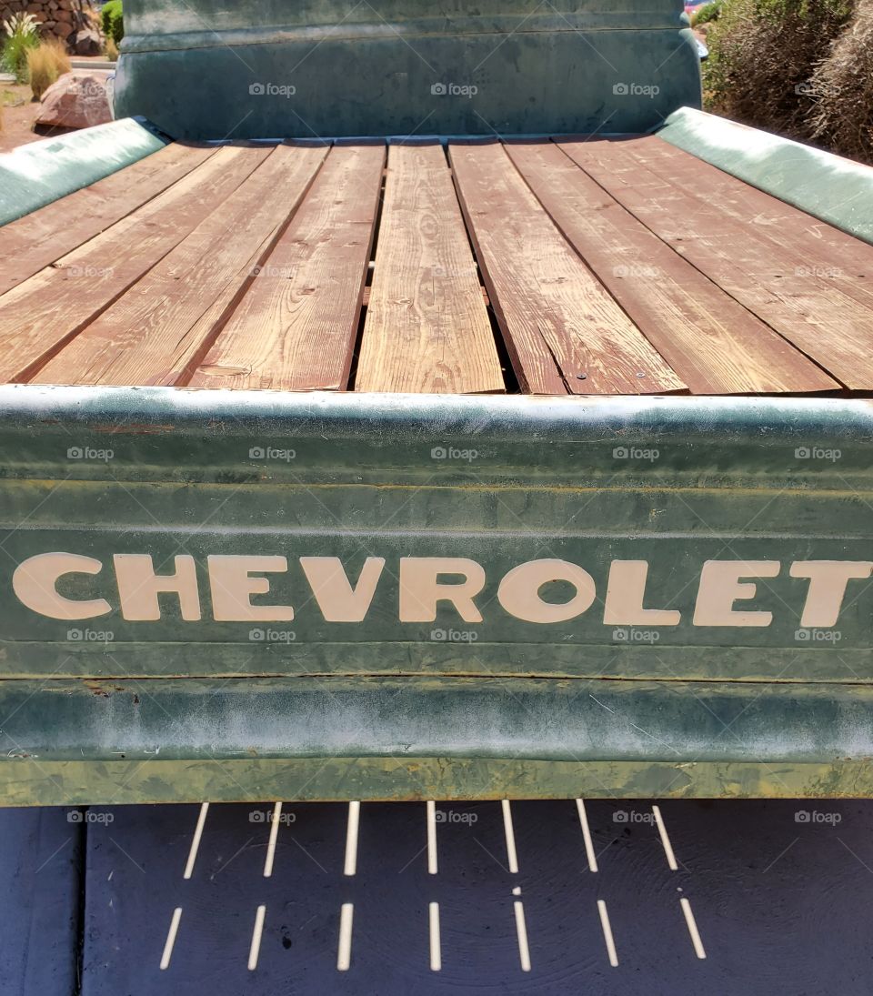 A slatted pickup truck bed shows signs of wear and damage after years baking in the Arizona desert sun