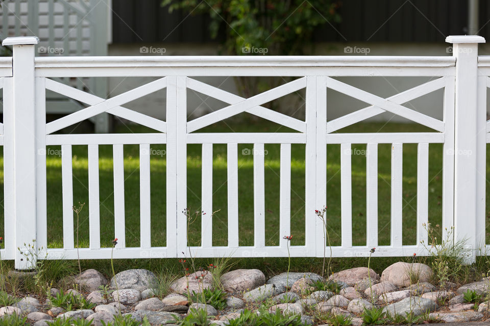 White wooden fence in the garden 
