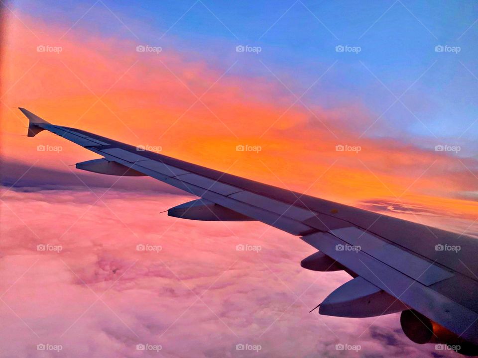 While flying high in the sky, the sunset drenched clouds looked so magnificent, as if  God painted it for me