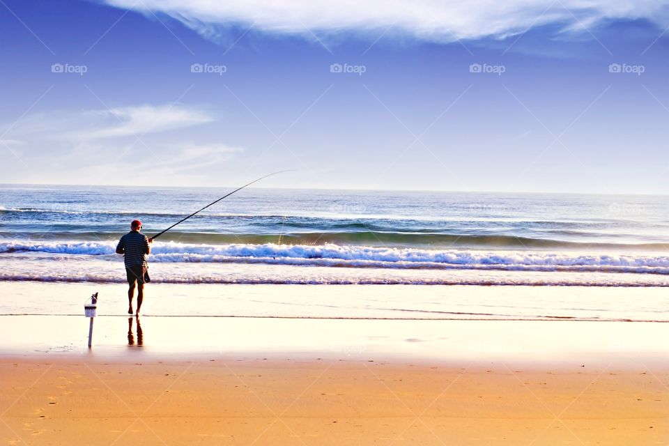 Beach fishing. Man fishing on beach 