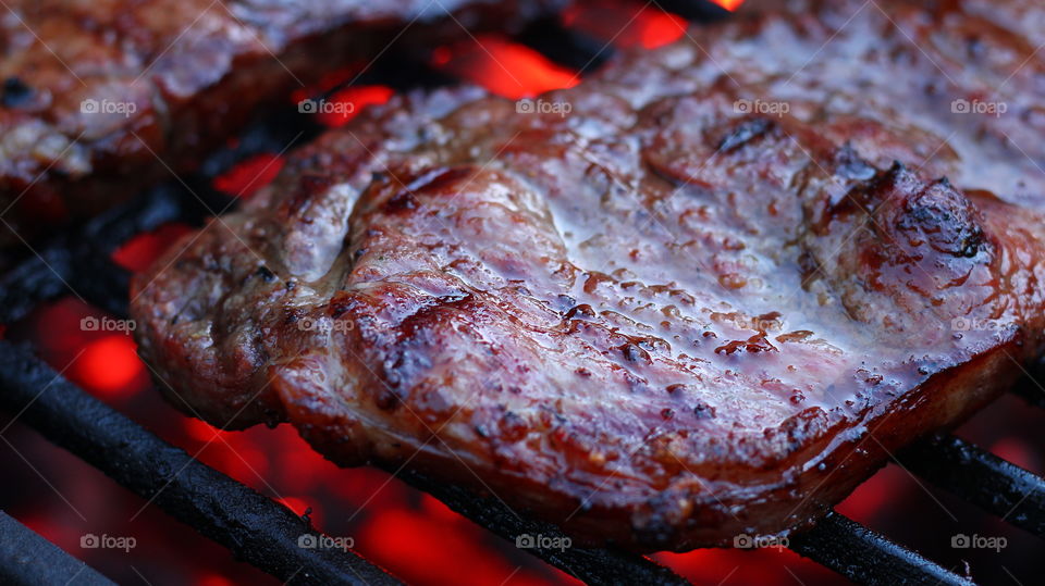 Juicy Steak on the Grill With Embers Glowing