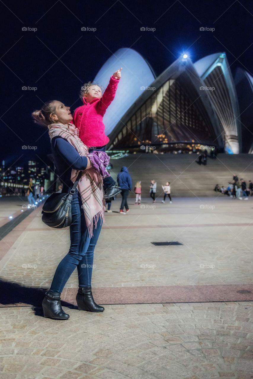 Mother and daughter standing in front of Sydney Opera House