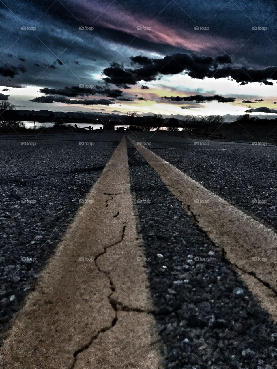 Road to Lake at Dusk. Trail of Double Yellow Lines 