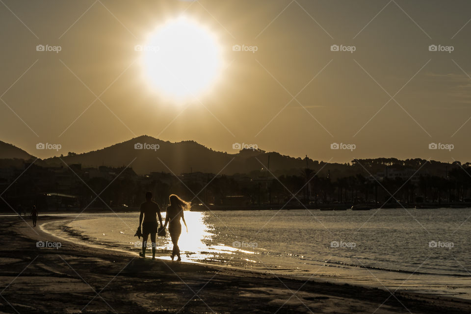 Walking on the beach at sunrise in Spain 