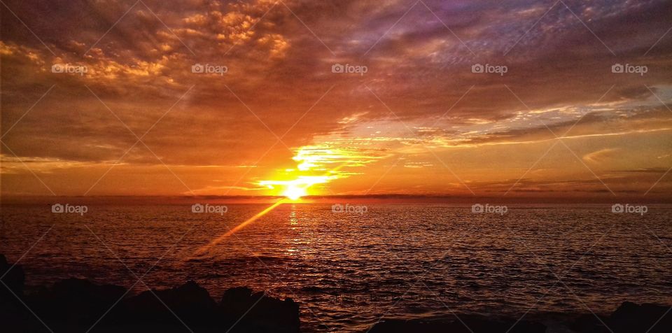 Sunset over the sea,sunset,sea,sky,sun,nature,reflection,landscape,colorful,spring,summer,sunlight shining,sunrise,dawn,ocean,water,coast,beach,clouds, sunshine