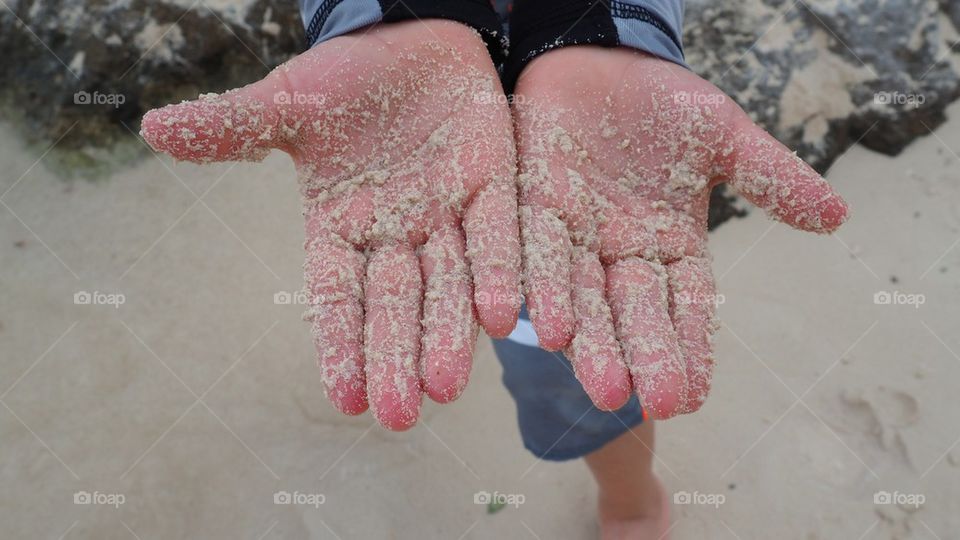 Hands covered in sand