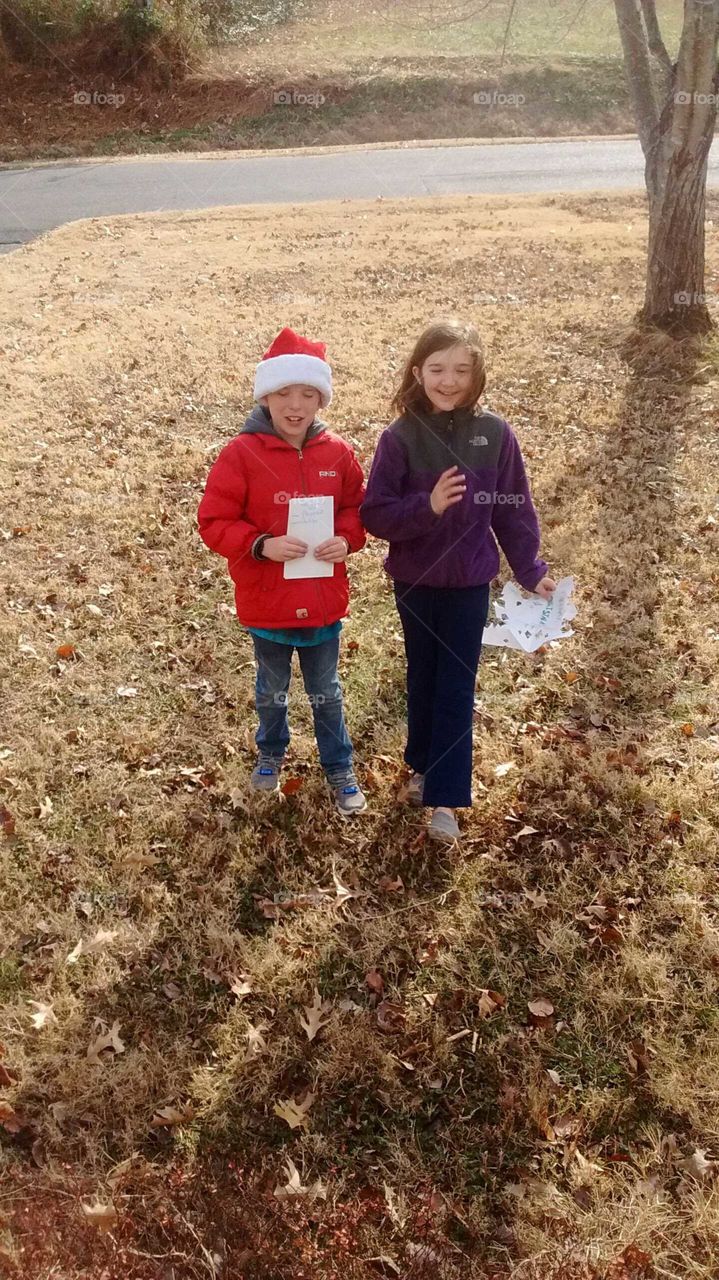 going around the block spreading holiday cheer and singing Christmas Carroll's