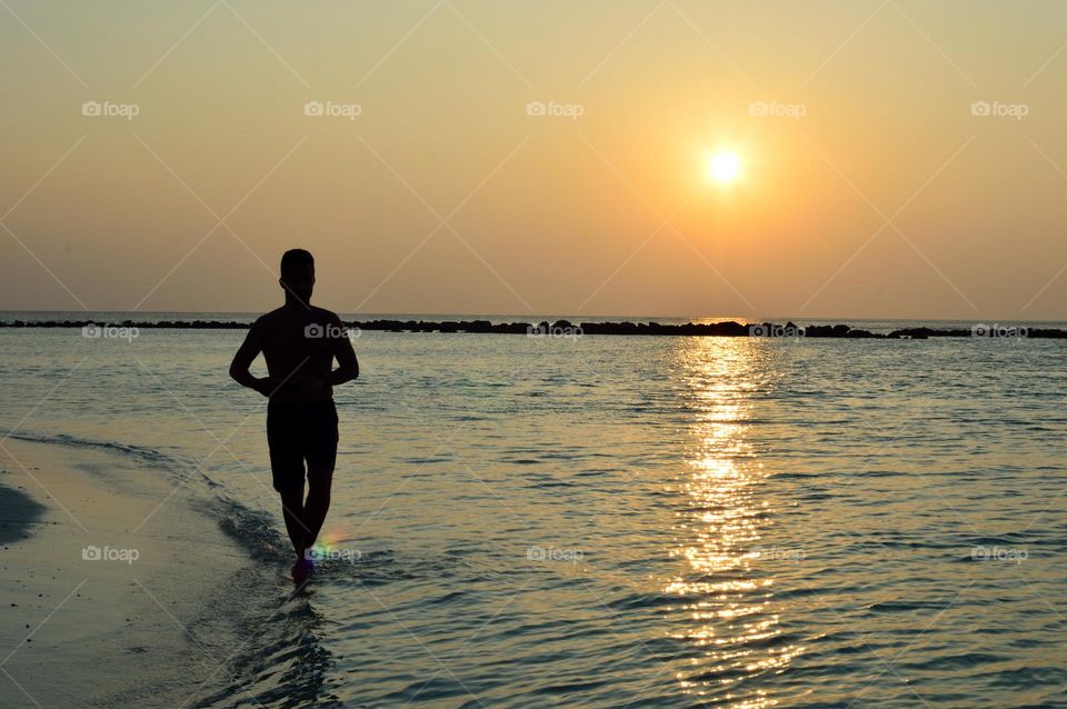 running by the sea at sunset