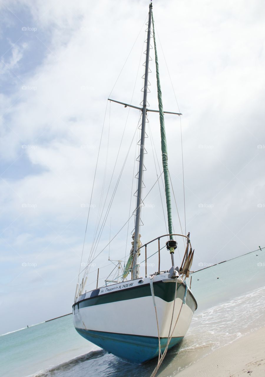 Sailboat ran aground at the beach after a hurricane