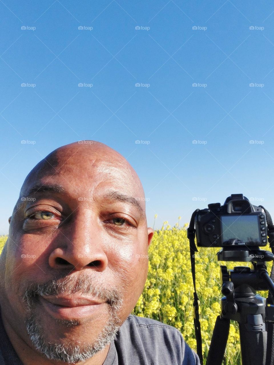 photographer enjoying nature in a field of flowers