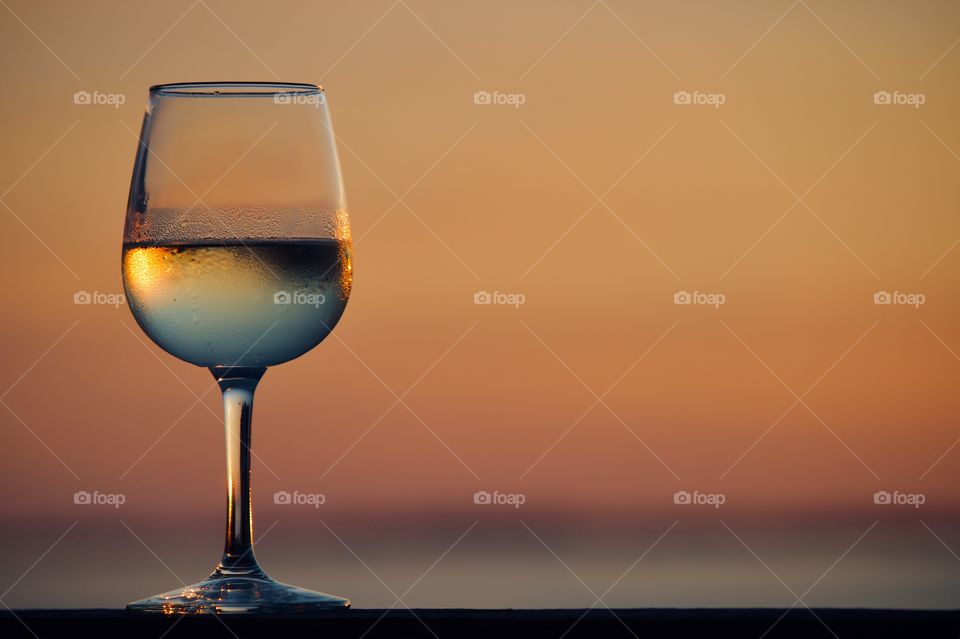 Glass of wine by the beach