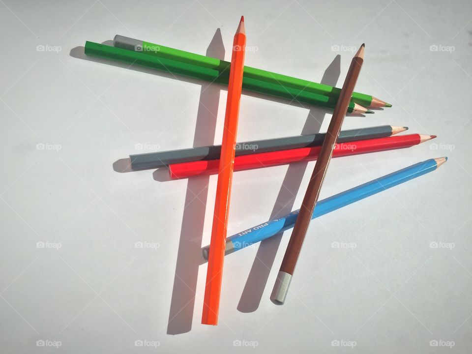 Colored pencils and their corresponding shadows