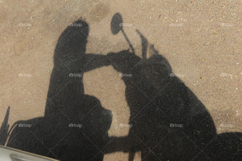 shadow of a motorcycle driver