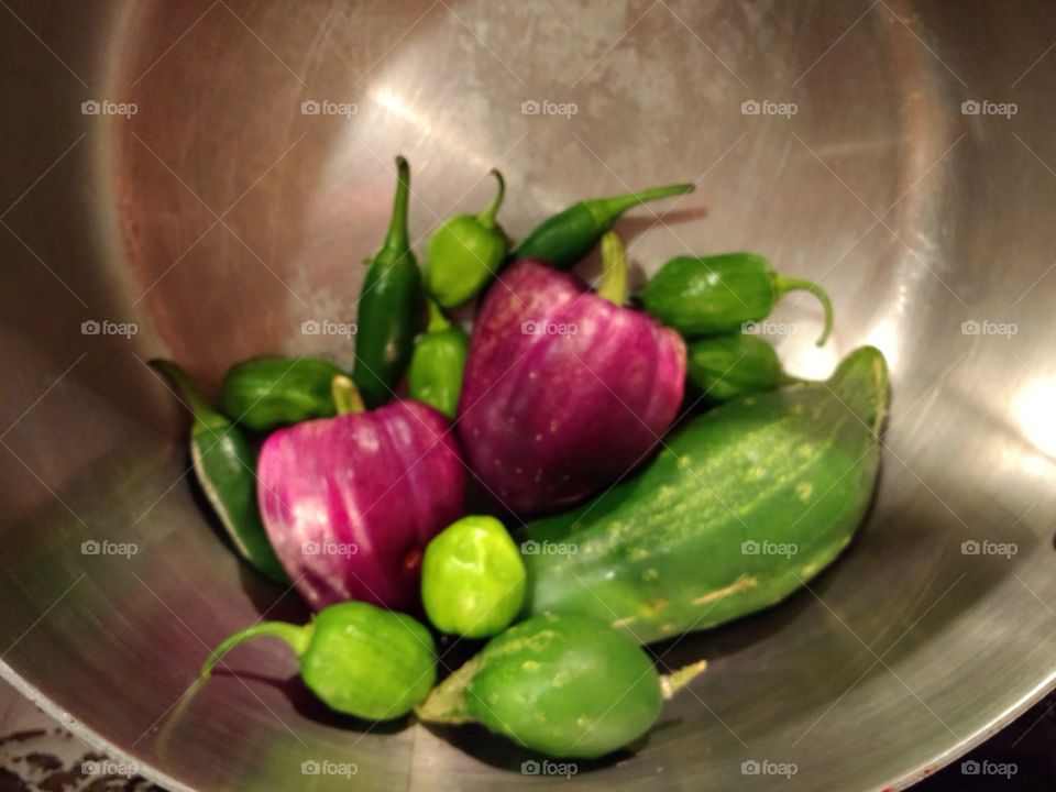 my colorful pot of peppers and cucumbers