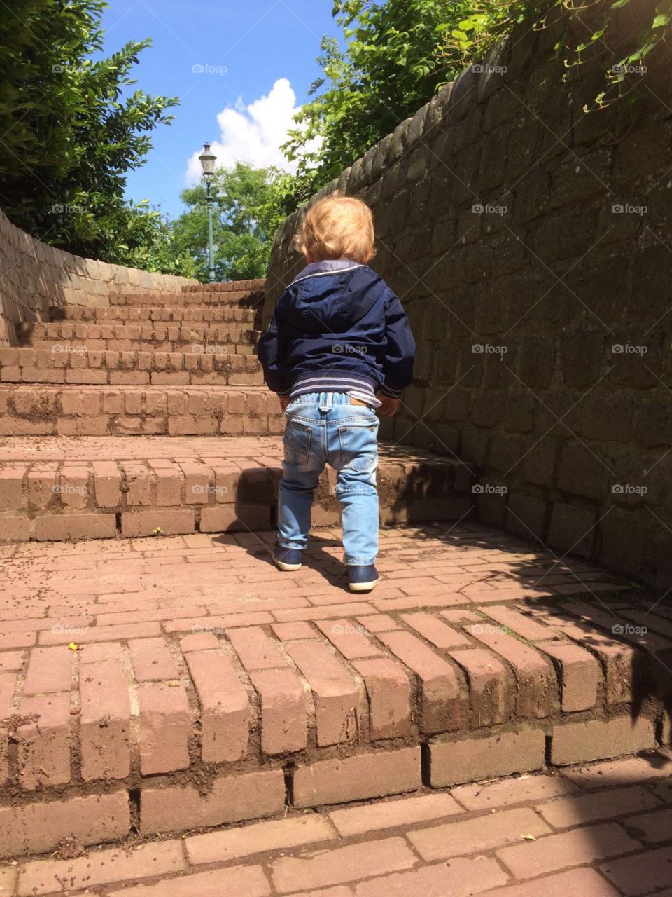 Little boy walking on stairs