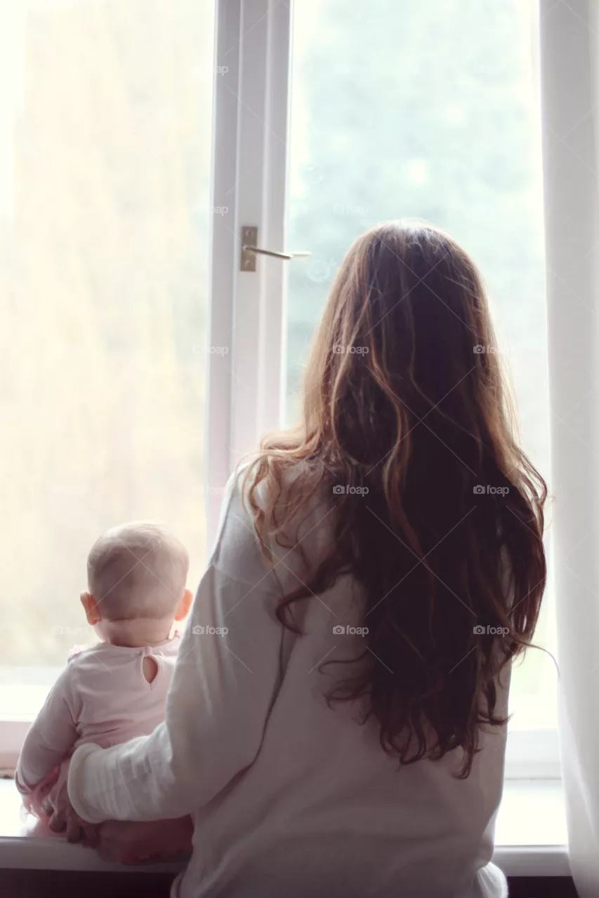 Mother and baby daughter together looking in the future 