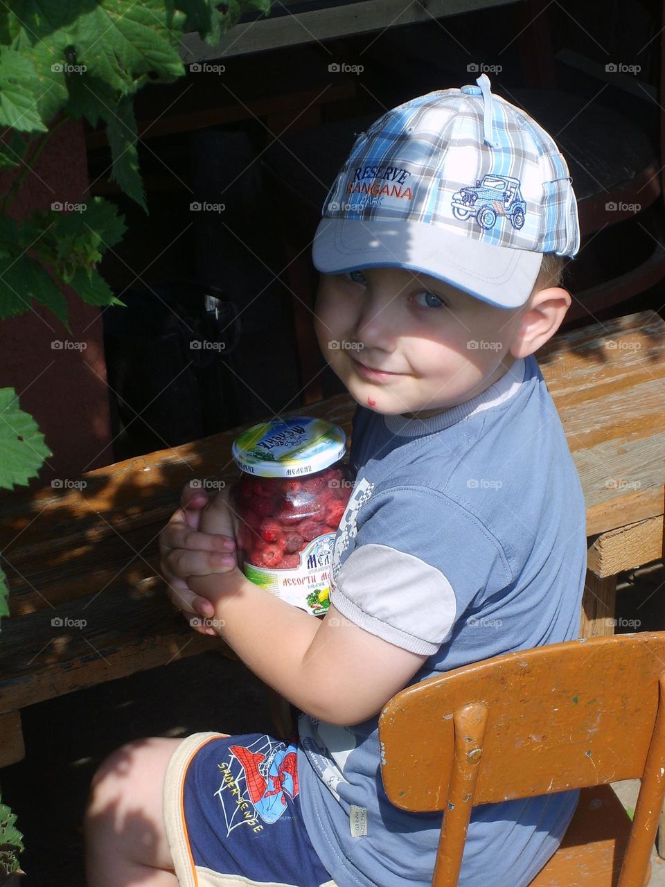 a little boy with raspberry