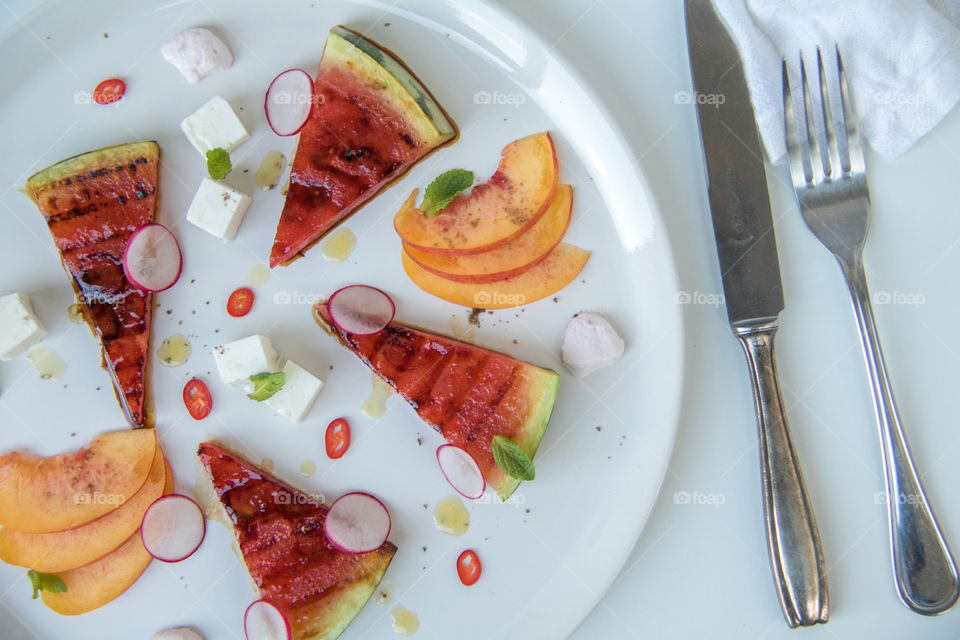 Homemade grilled watermelon salad with peaches and feta