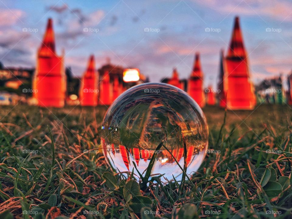 Top view of lensball,  crystal ball at the Adriatic seaside against sunset sky close up