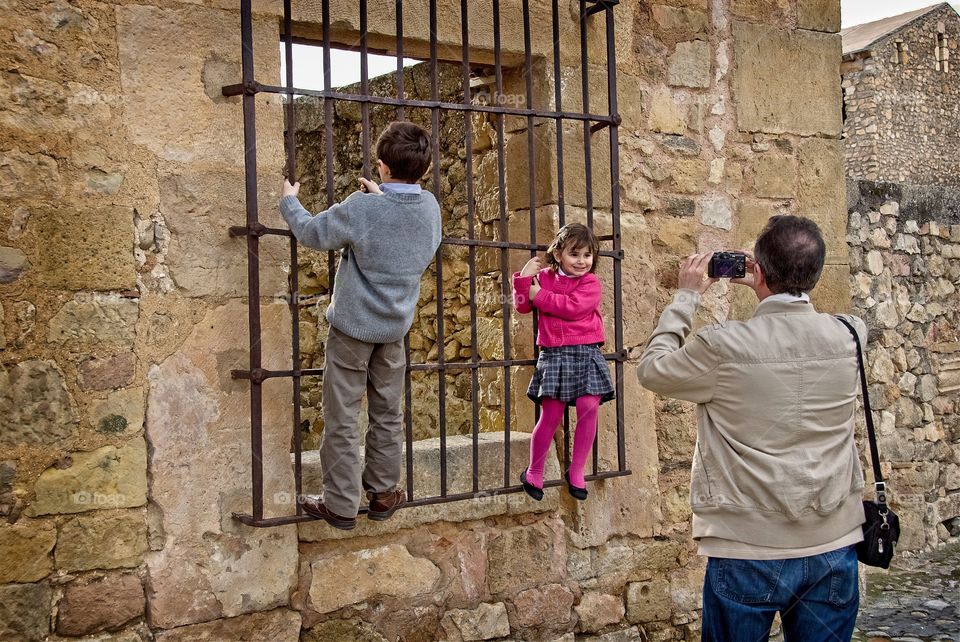 A man takes a photo of his kids 