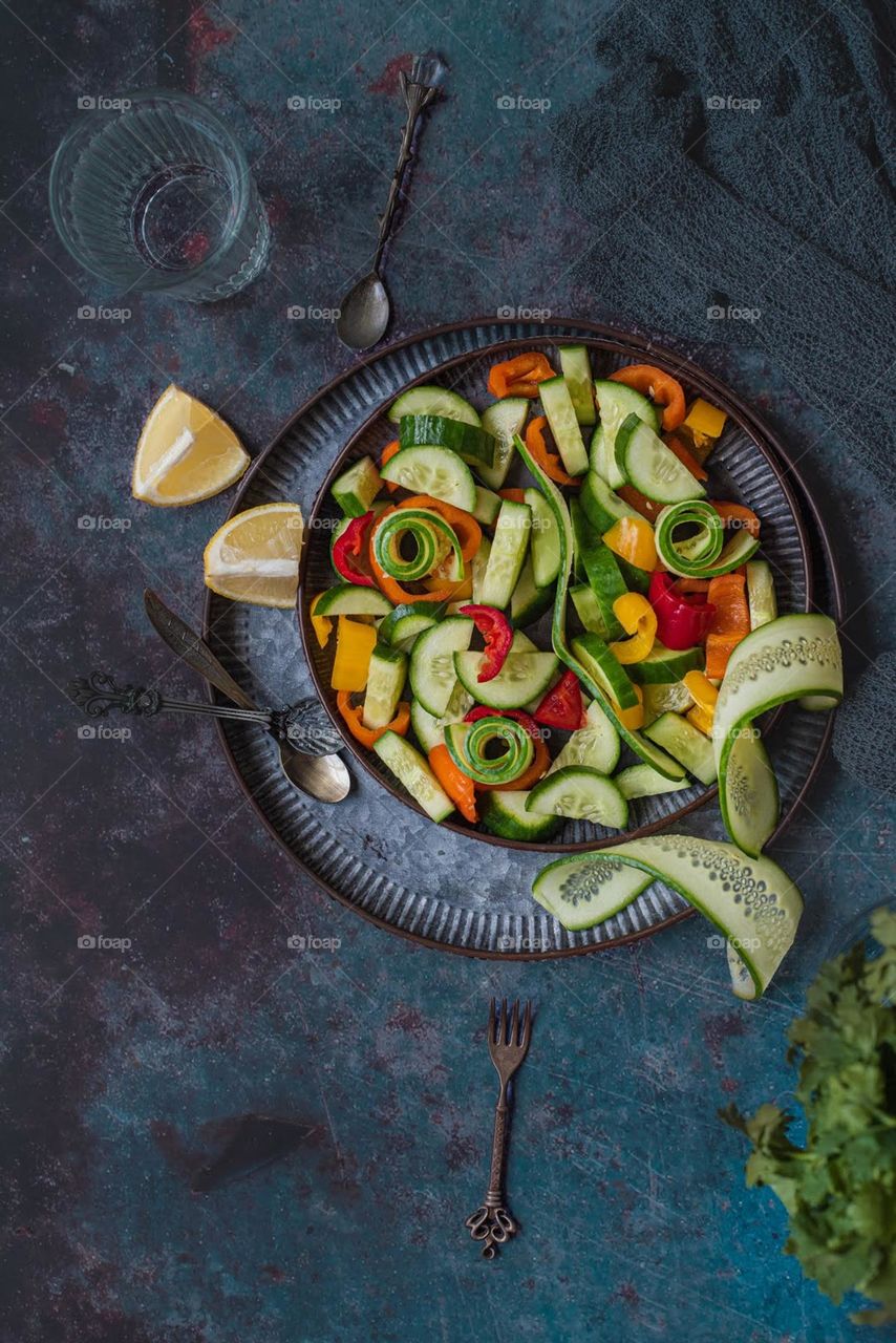 Cucumber, red, orange, yellow sweet pepper salad