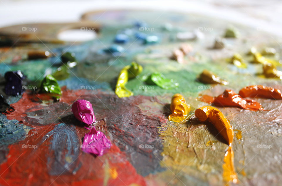 Colorful artist palette, oil paint texture, close up view