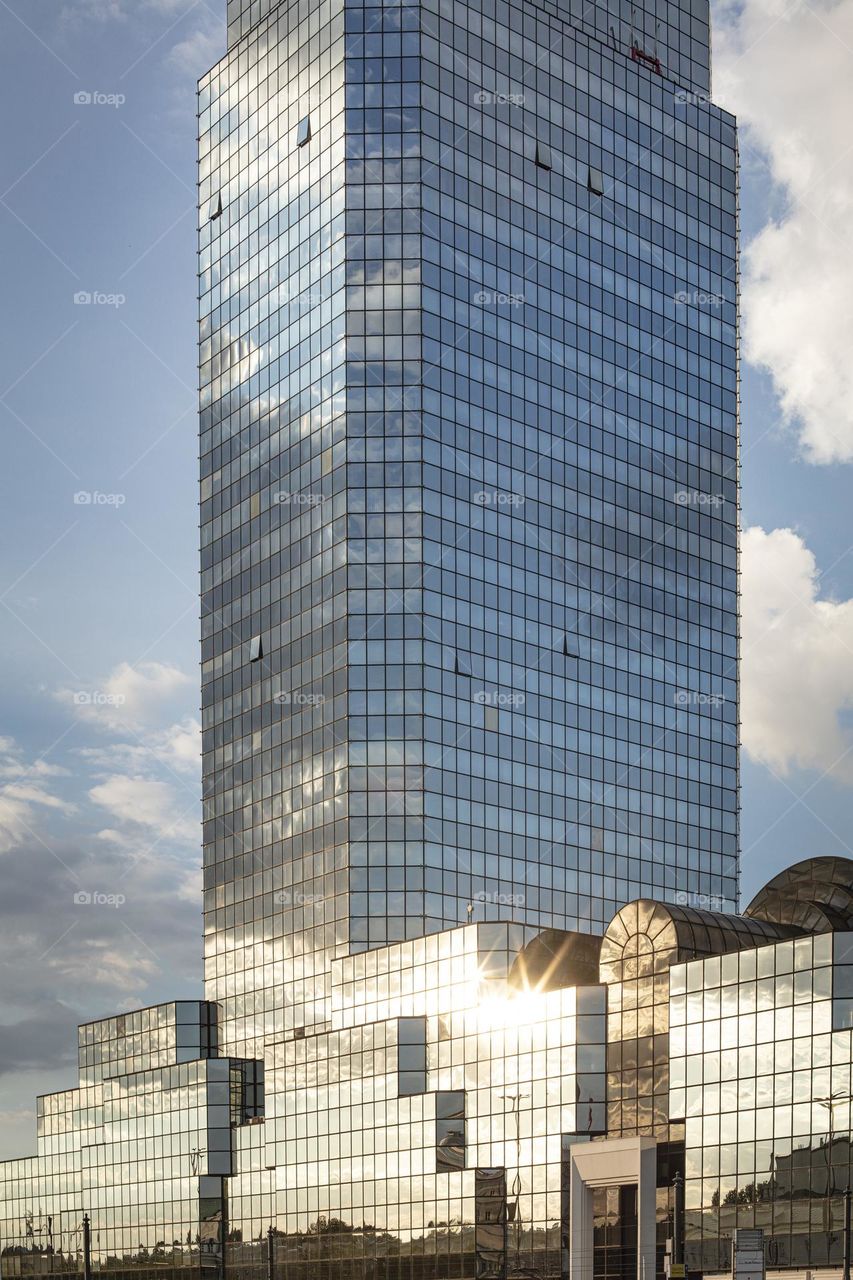 skyscraper windows reflecting clouds