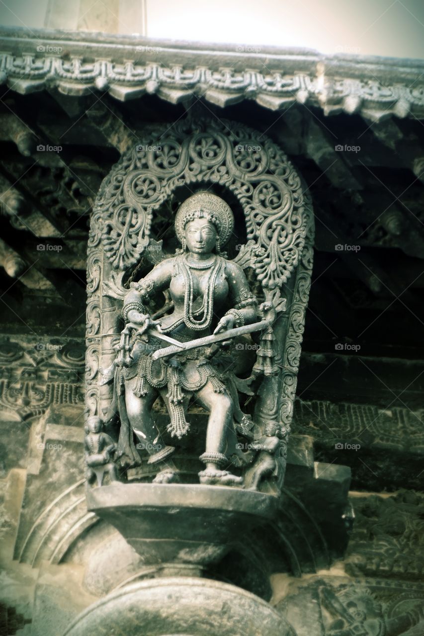 Belur Chennakeshava temple Apsara playing musical instrument