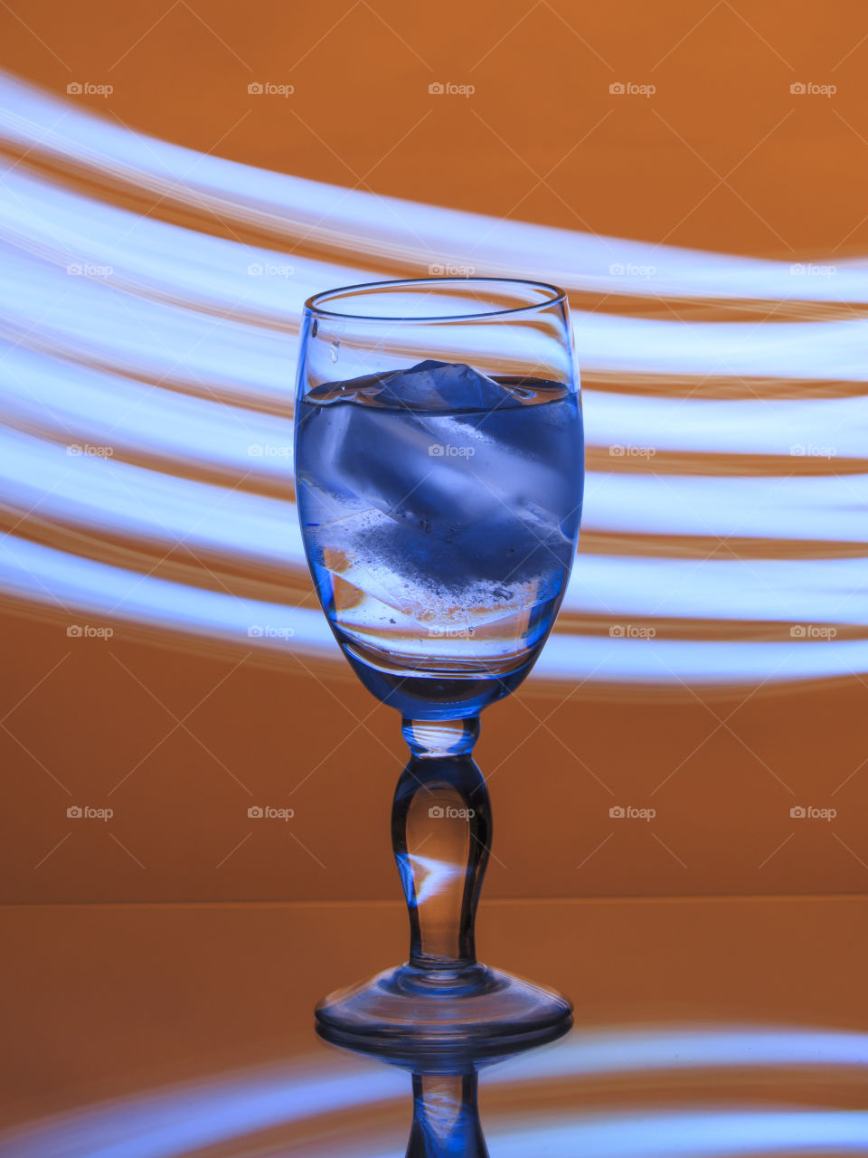 Glass of water with blue ice