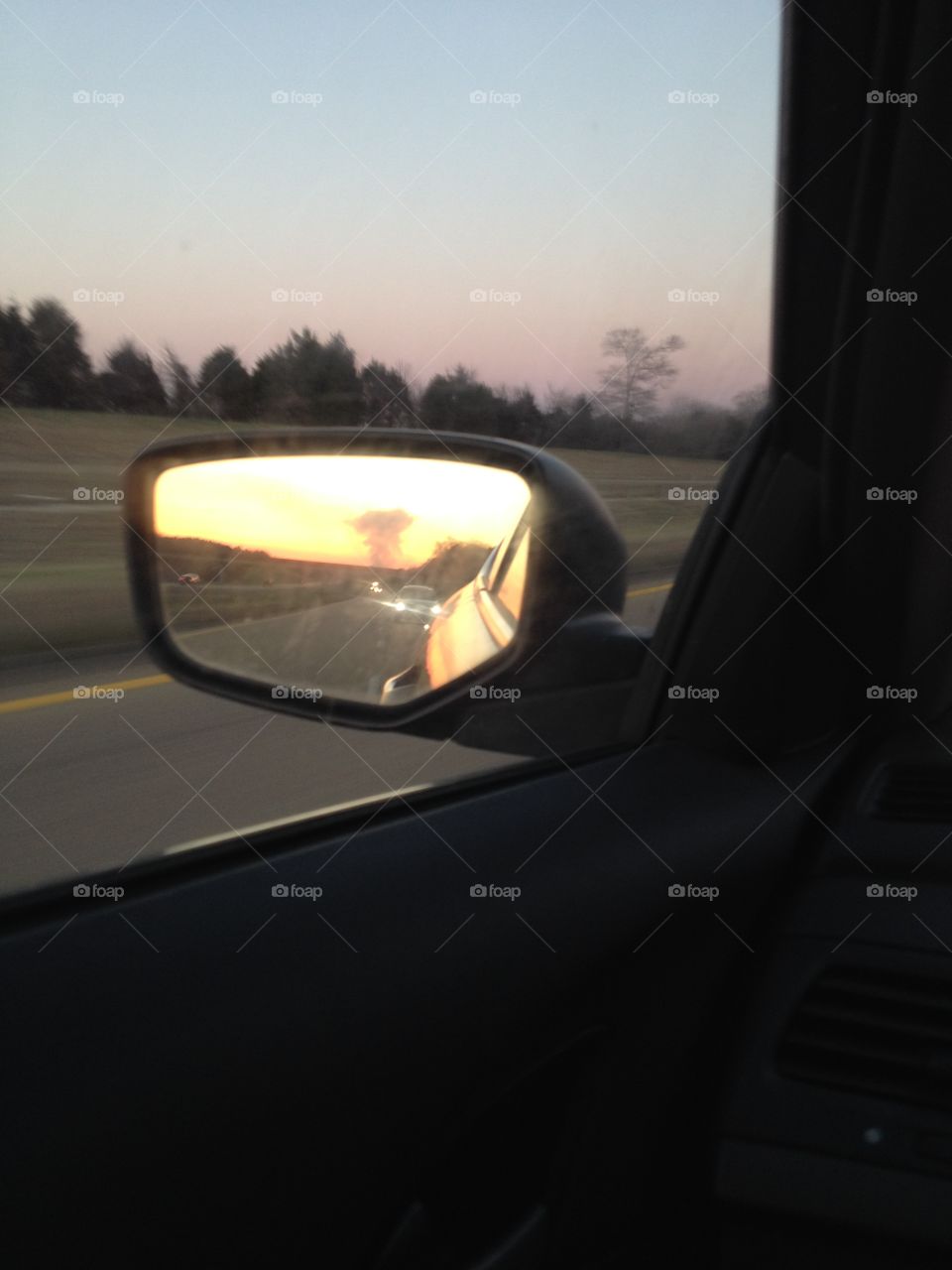 Mushroom smoke cloud in side rear view mirror.