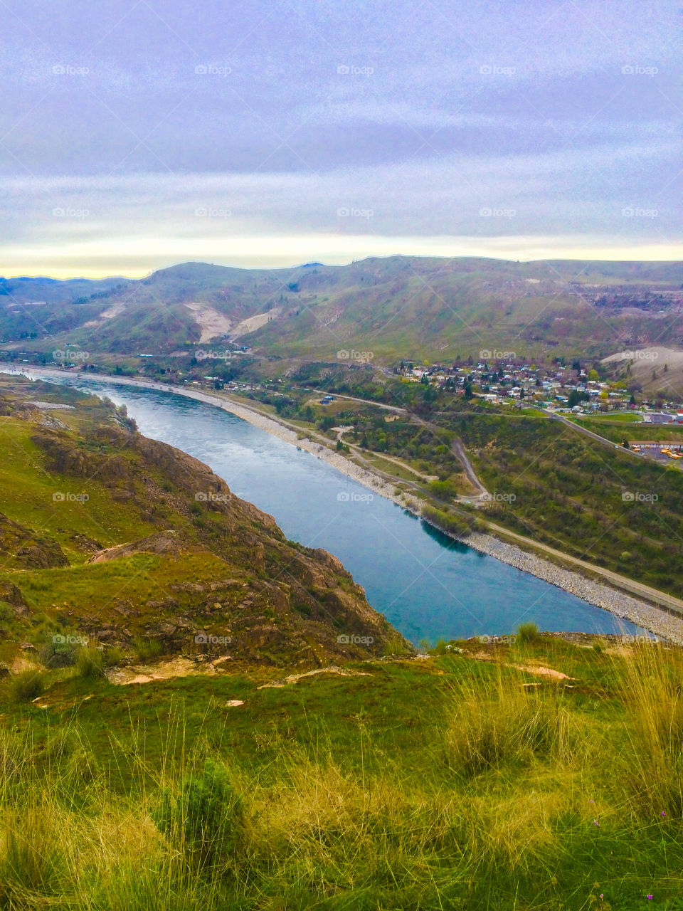 Vibrant landscape of the Columbia river with rural town below 