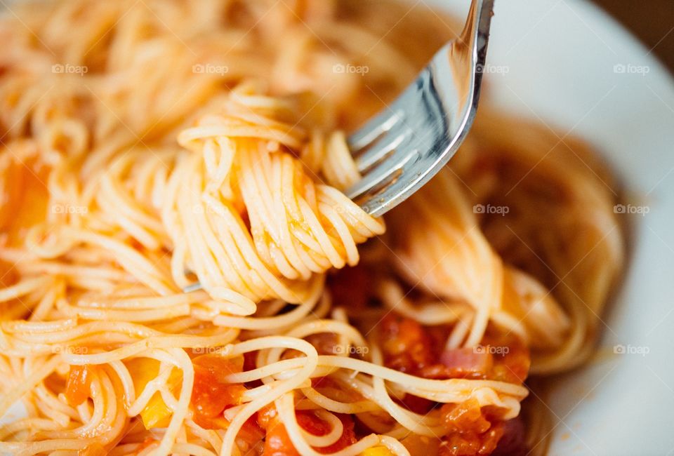 Close-up of spaghetti rolled on fork