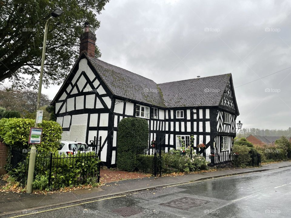 Black and white Shropshire house snapped with fast approaching Storm clouds 