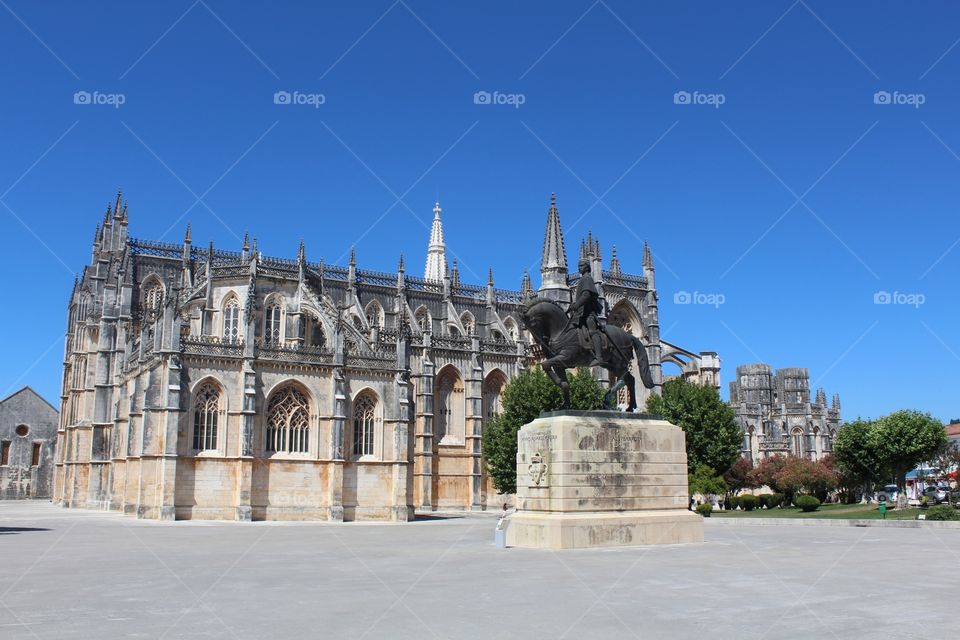 The Monastery of the Dominicans of Batalha, officially known as the Monastery of Saint Mary of the Victory (Portuguese: Mosteiro de Santa Maria da Vitória), was built to commemorate the victory of the Portuguese over the Castilians at the battle of Aljubarrota in 1385. It was to be the Portuguese monarchy's main building project for the next two centuries, and would serve as the burial church of the 15th-Century Aviz dynasty. It is one of the best and original examples of Late Gothic architecture in Portugal, intermingled with the Manueline style.