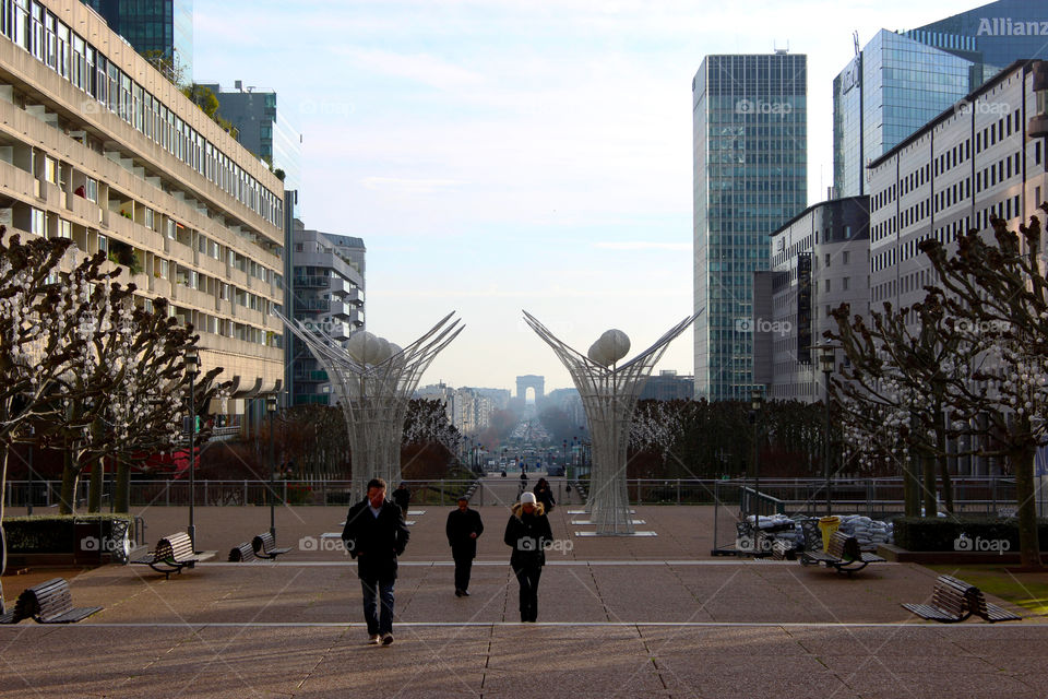 Tourists among the skyscrapers of Paris with the horizon the great triumphal arch.