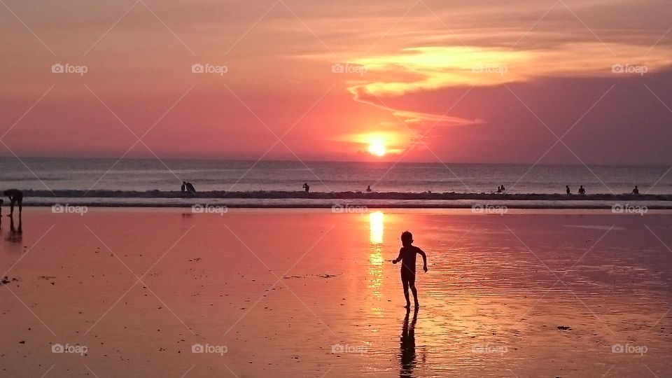the attraction . Sunset at kuta beach, always been an amazing attractions for everyone. but this little boy got my attention of him 