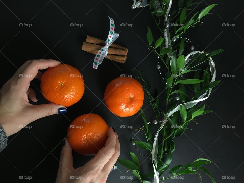 Women holding orange fruit