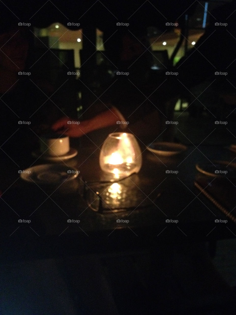 Candle on the table in the restaurant in the night